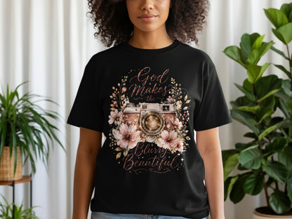Black t-shirt with a vintage camera surrounded by flowers and text.
