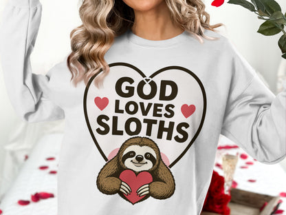 White sweatshirt with "GOD LOVES SLOTHS" text and a sloth graphic holding a heart.
