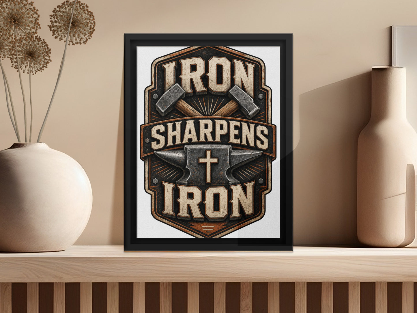 Framed artwork with text "Iron Sharpens Iron" and religious cross symbol.