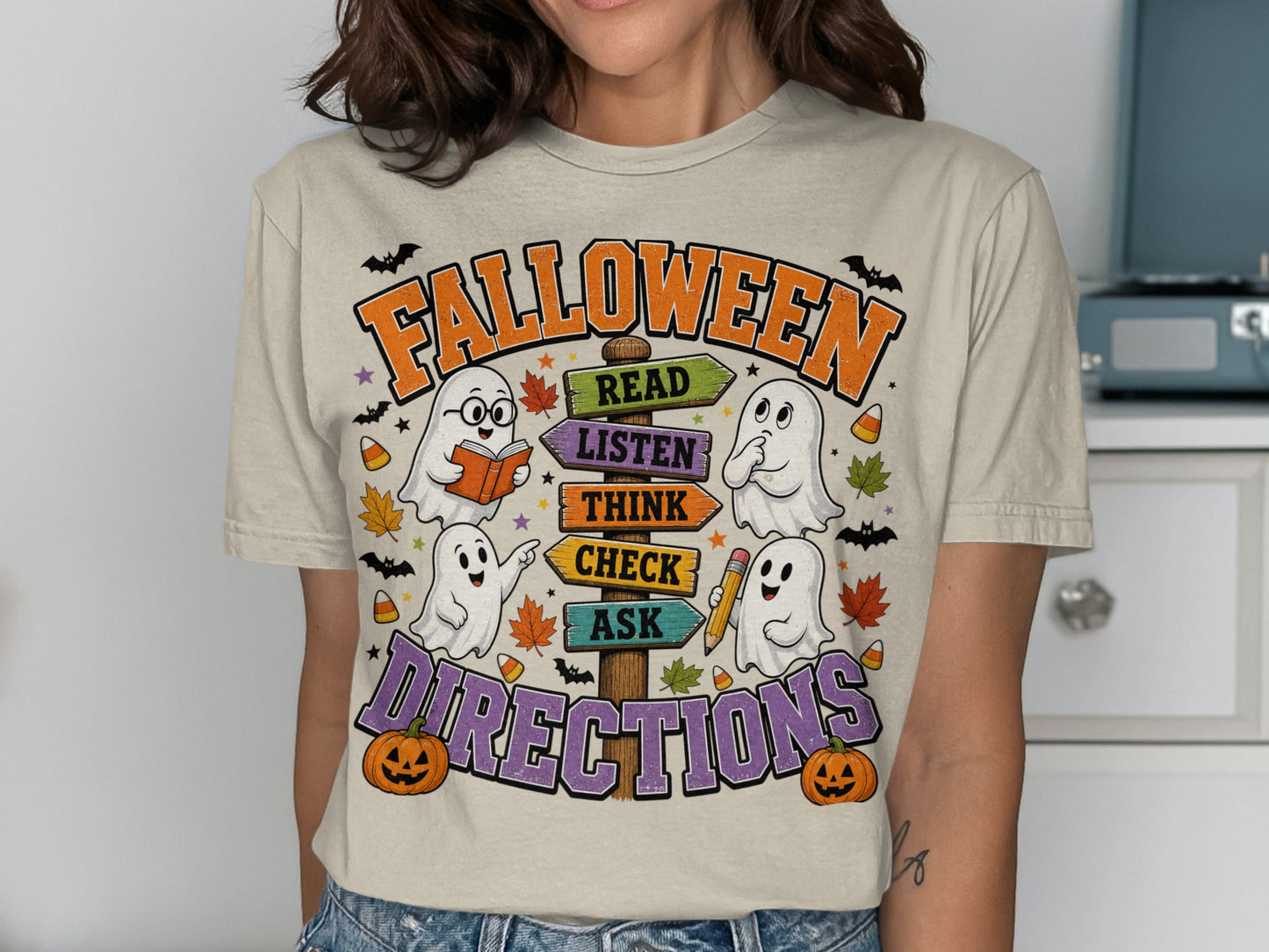 Halloween shirt with ghosts, pumpkins, and directional signs for read, listen, think, check, ask.