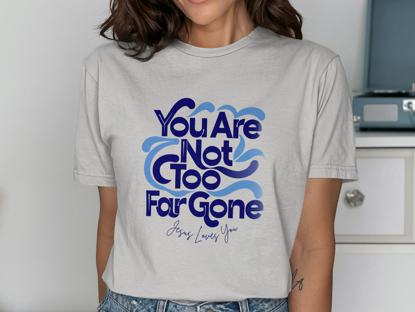 Grey t-shirt with "You Are Not Too Far Gone Jesus Loves You" text.