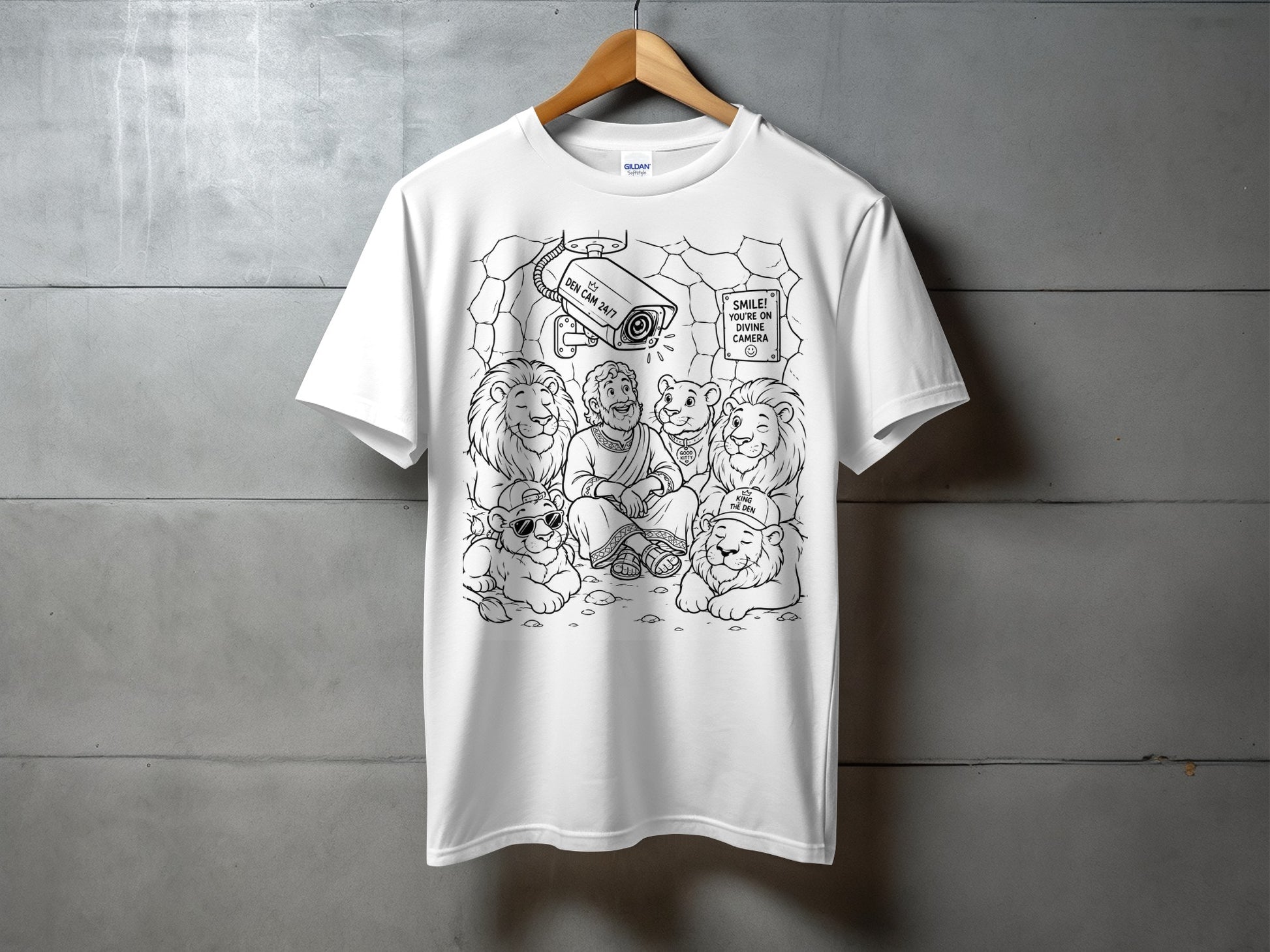 T-shirt with lions in a den and a security camera labeled "Divine Camera."