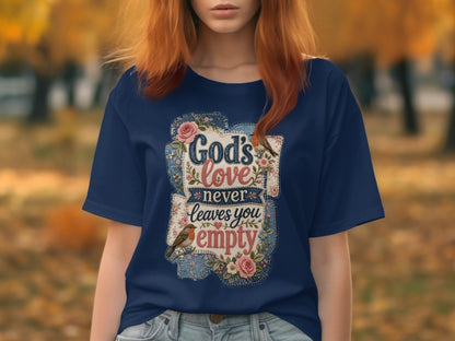 Dark blue t-shirt with floral and bird graphic and "God's love never leaves you empty" text.