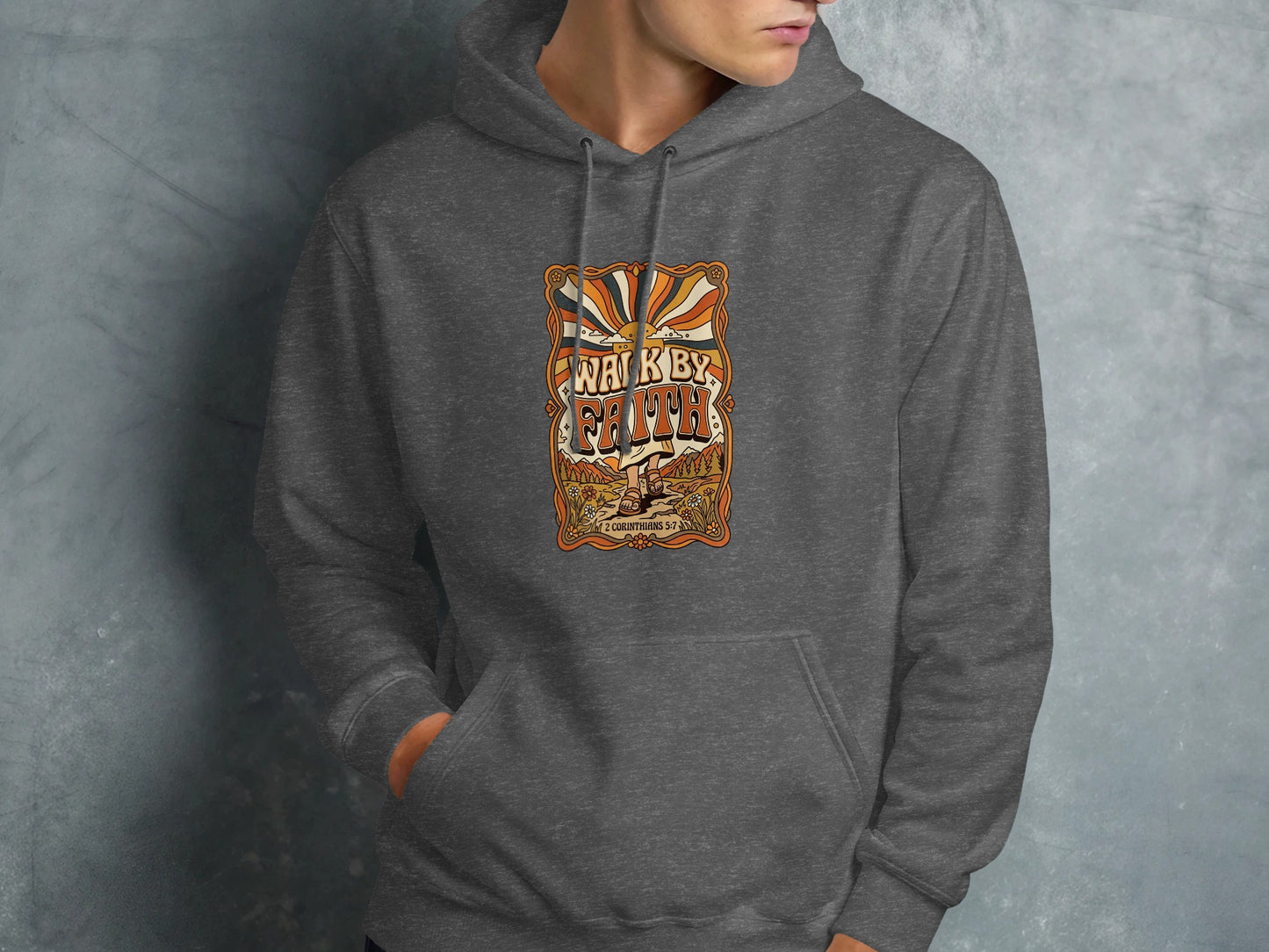 Dark grey hoodie featuring "Walk by Faith" text with sunburst and nature scene.