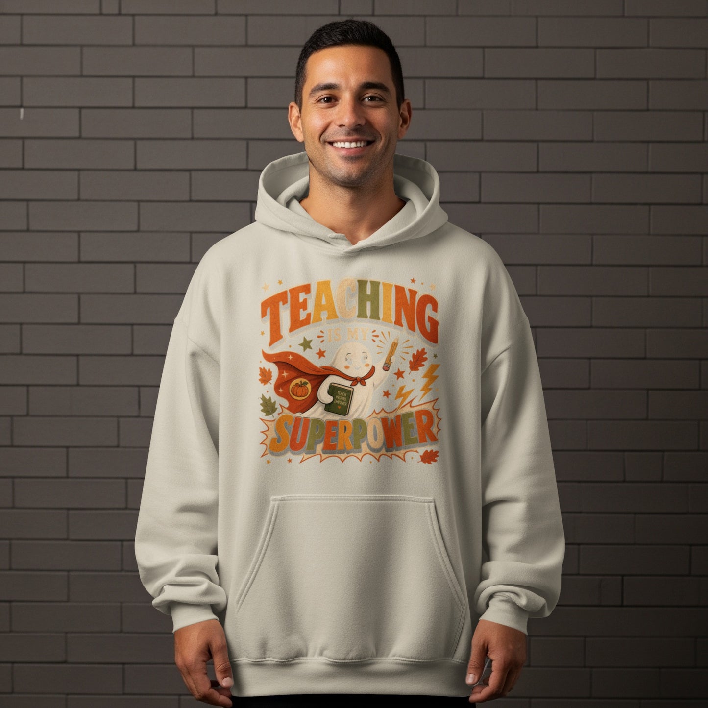 Light gray hoodie with "Teaching Is My Superpower" text and a cute ghost holding a book and pencil.