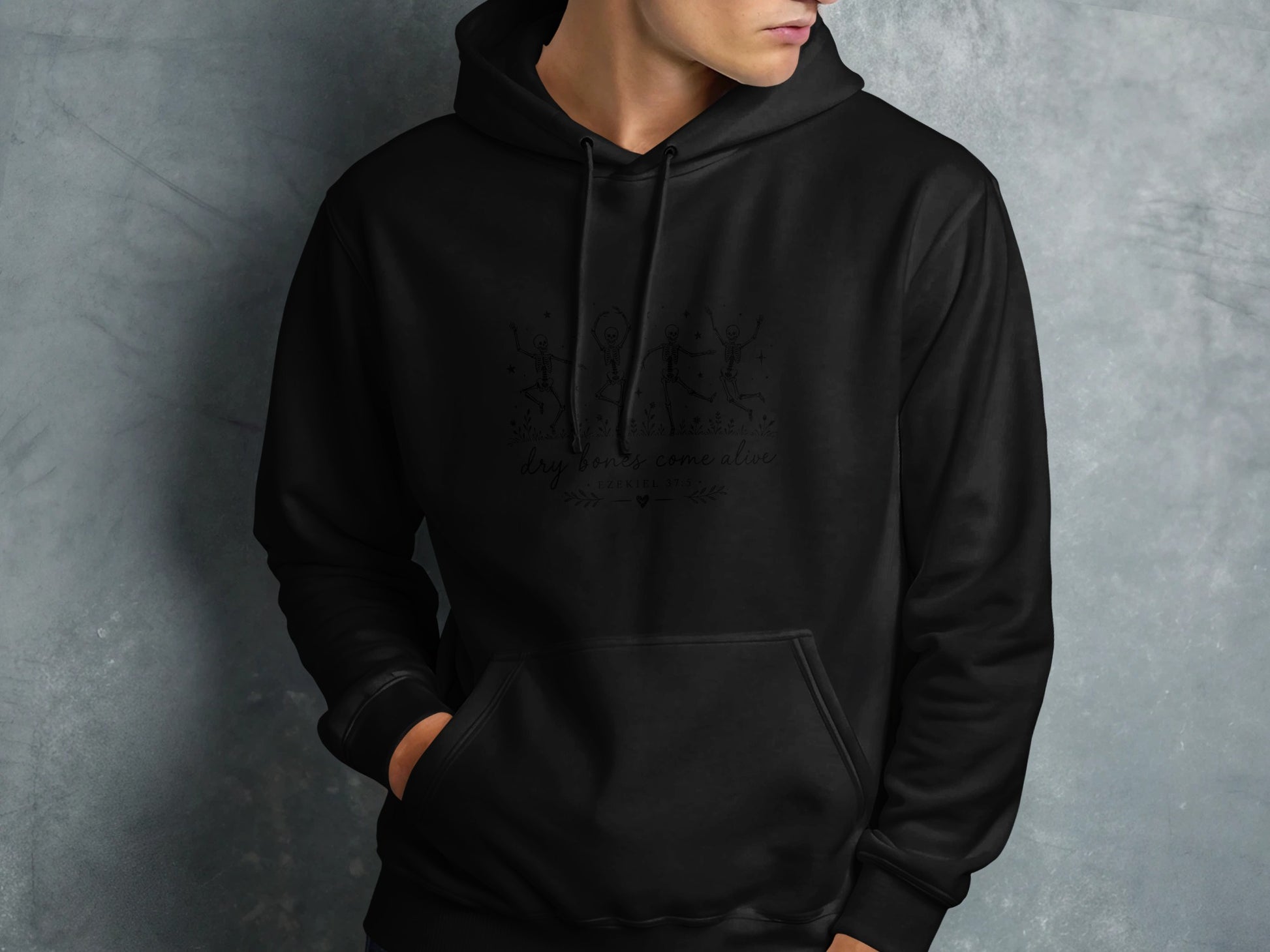Black hoodie with skeleton dancers graphic and text.