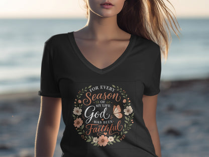 Woman wearing a black v-neck t-shirt with floral and butterfly text design.