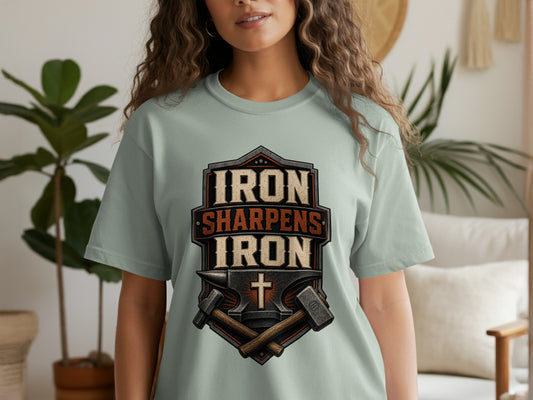 T-shirt graphic with text "IRON SHARPENS IRON" and anvil with hammers.