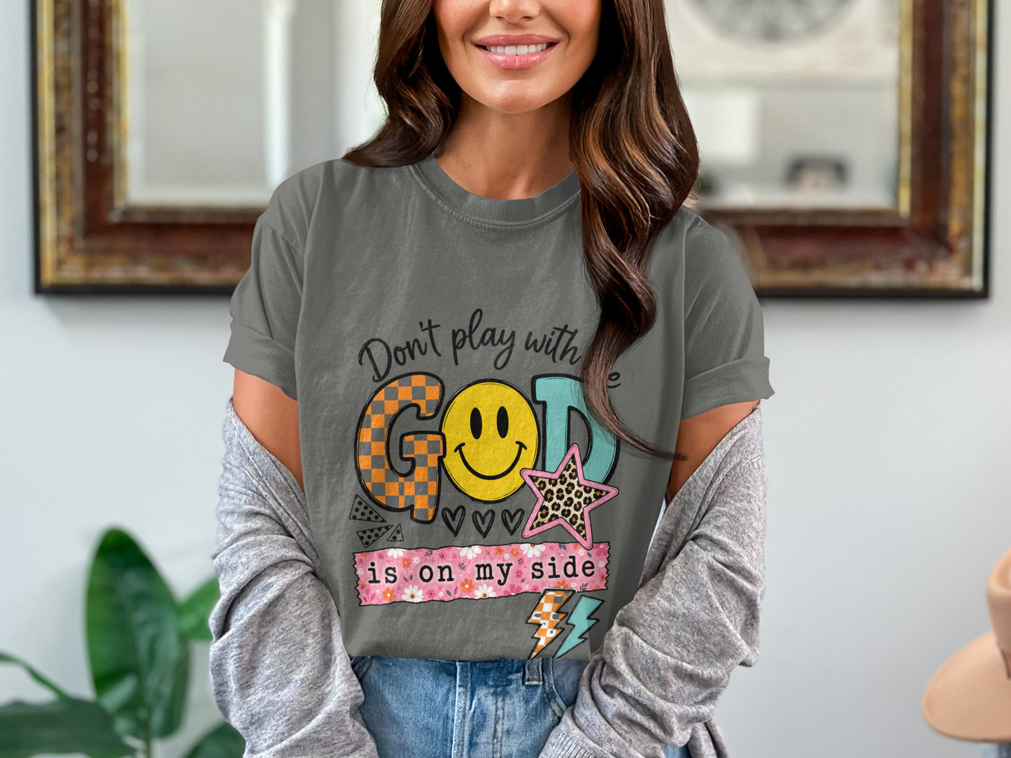Graphic t-shirt with text "Don't play with God is on my side" and smiley face.