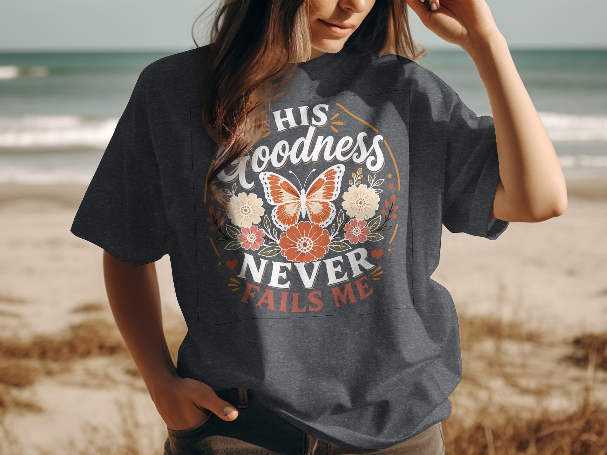 Dark grey t-shirt with floral butterfly graphic and text "HIS goodness never fails me".