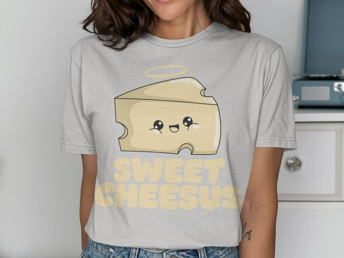 Cartoon cheese wedge with halo and "SWEET CHEESUS" text.