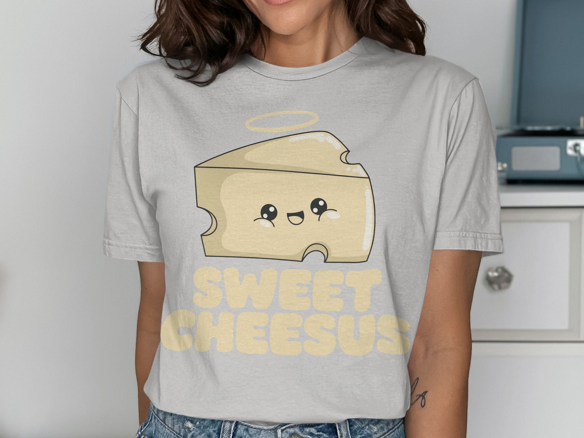 Cartoon cheese wedge with halo and "SWEET CHEESUS" text.