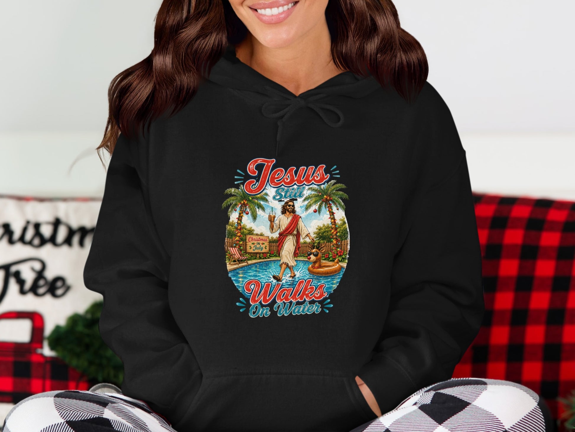 Jesus Still Walks On Water graphic on black hoodie with pool and palm trees.