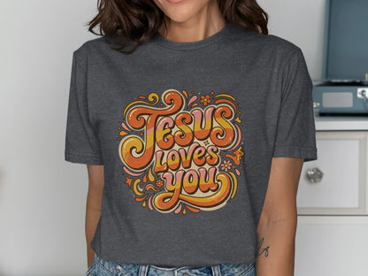 Dark grey t-shirt featuring "Jesus Loves You" in groovy, colorful lettering.
