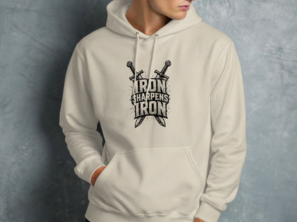 Cream hoodie with crossed swords and text "IRON SHARPENS IRON".