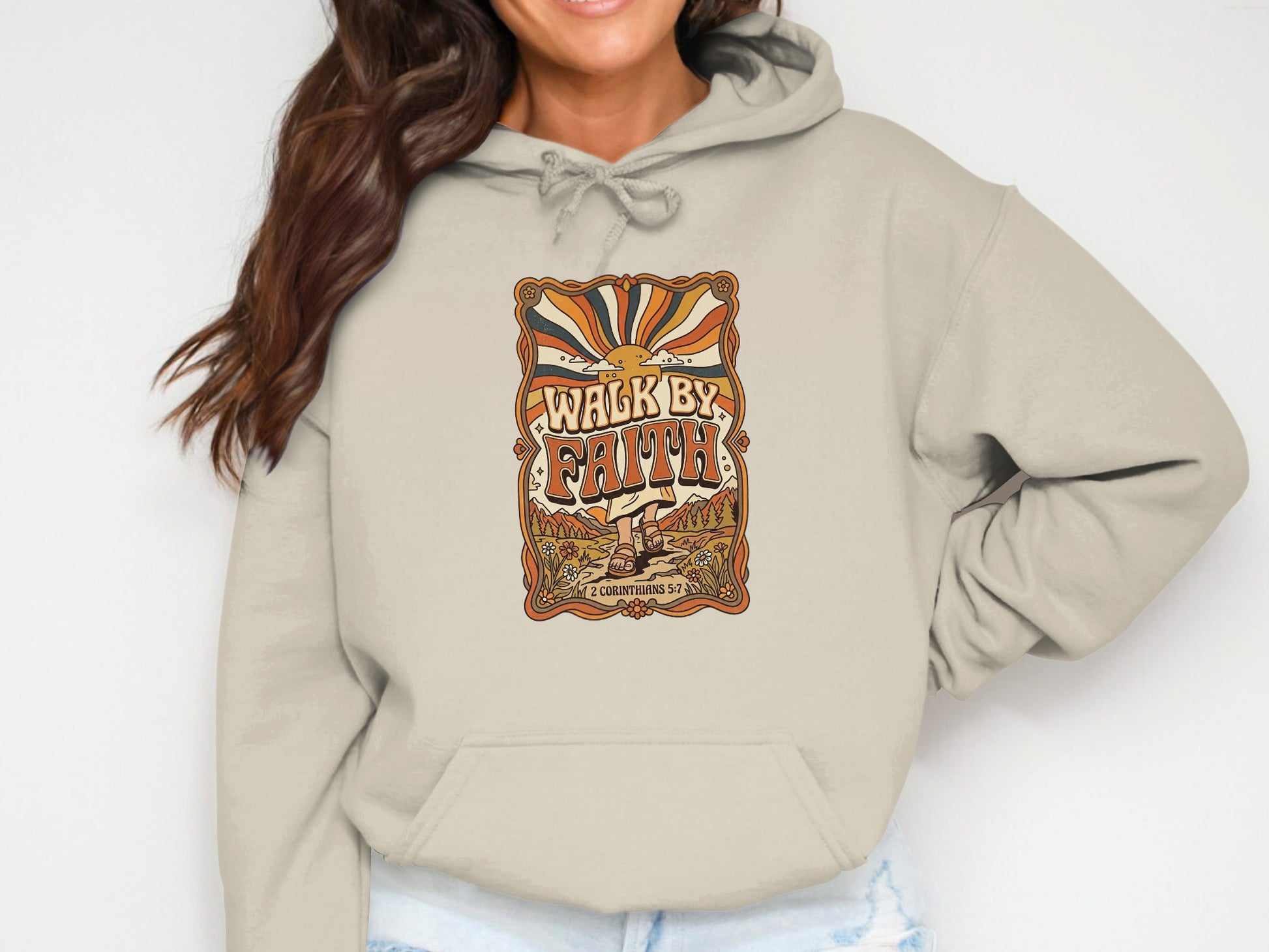 Beige hoodie with "Walk by Faith" text and retro sun graphic.