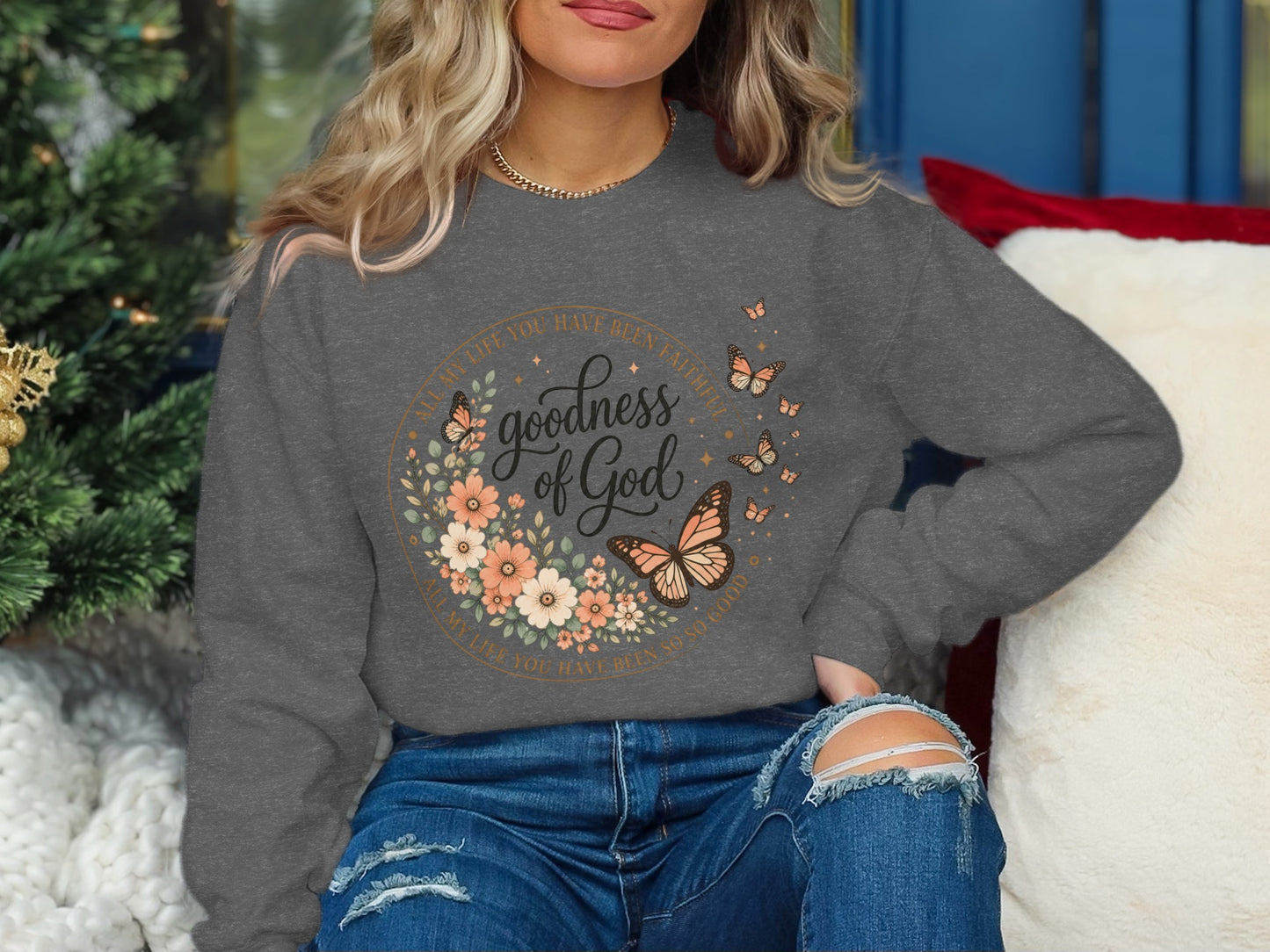 Gray sweatshirt with "goodness of God" floral and butterfly design.