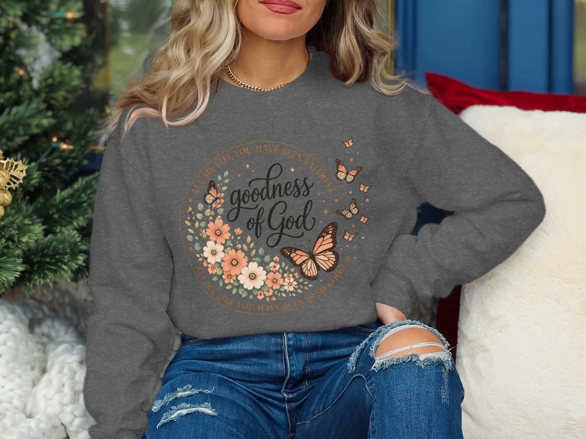 Gray sweatshirt with "goodness of God" floral and butterfly design.