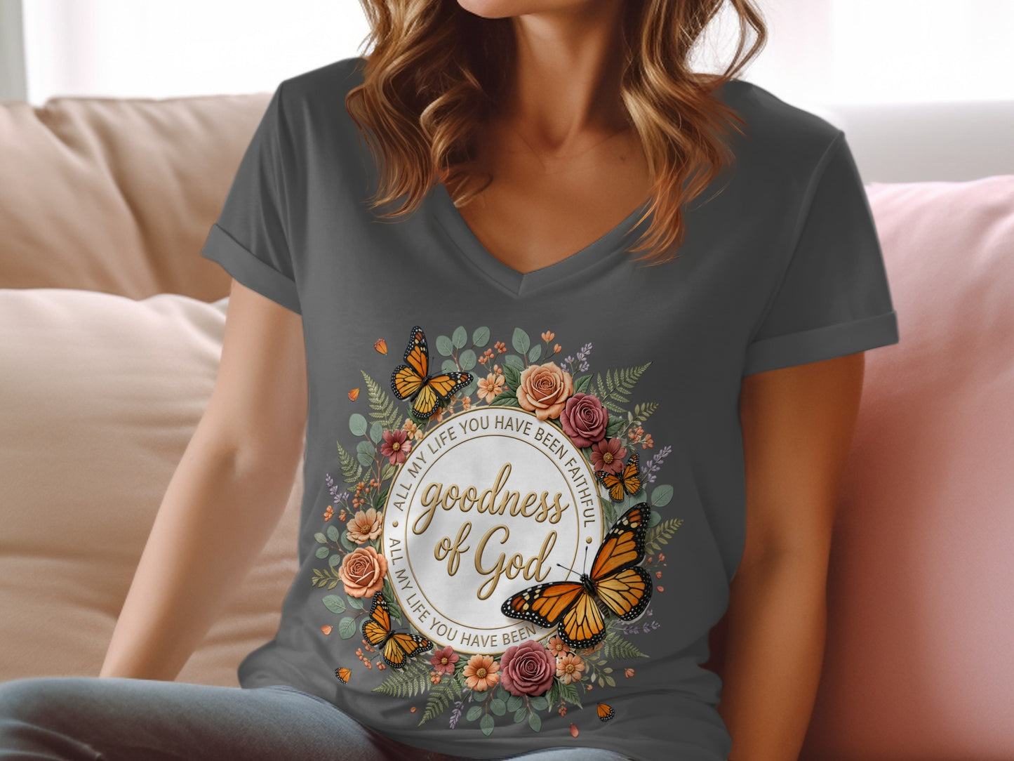 Dark t-shirt with floral wreath and "Goodness of God" text.