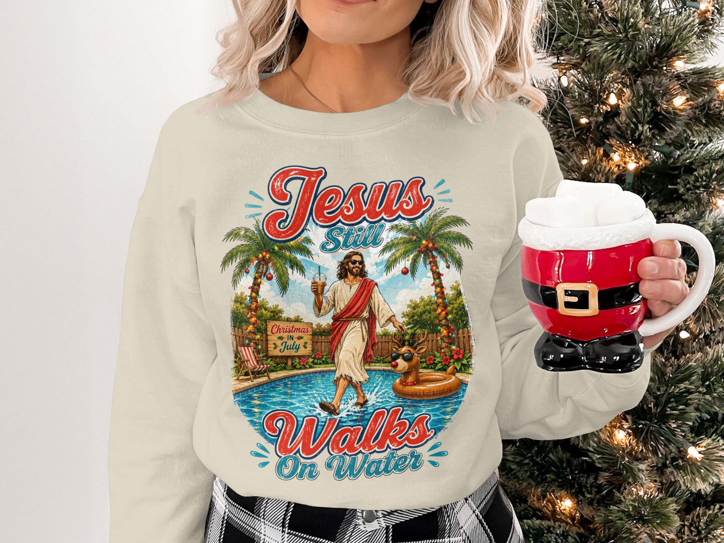 Cream sweatshirt with "Jesus Still Walks On Water" graphic and Christmas decorations.