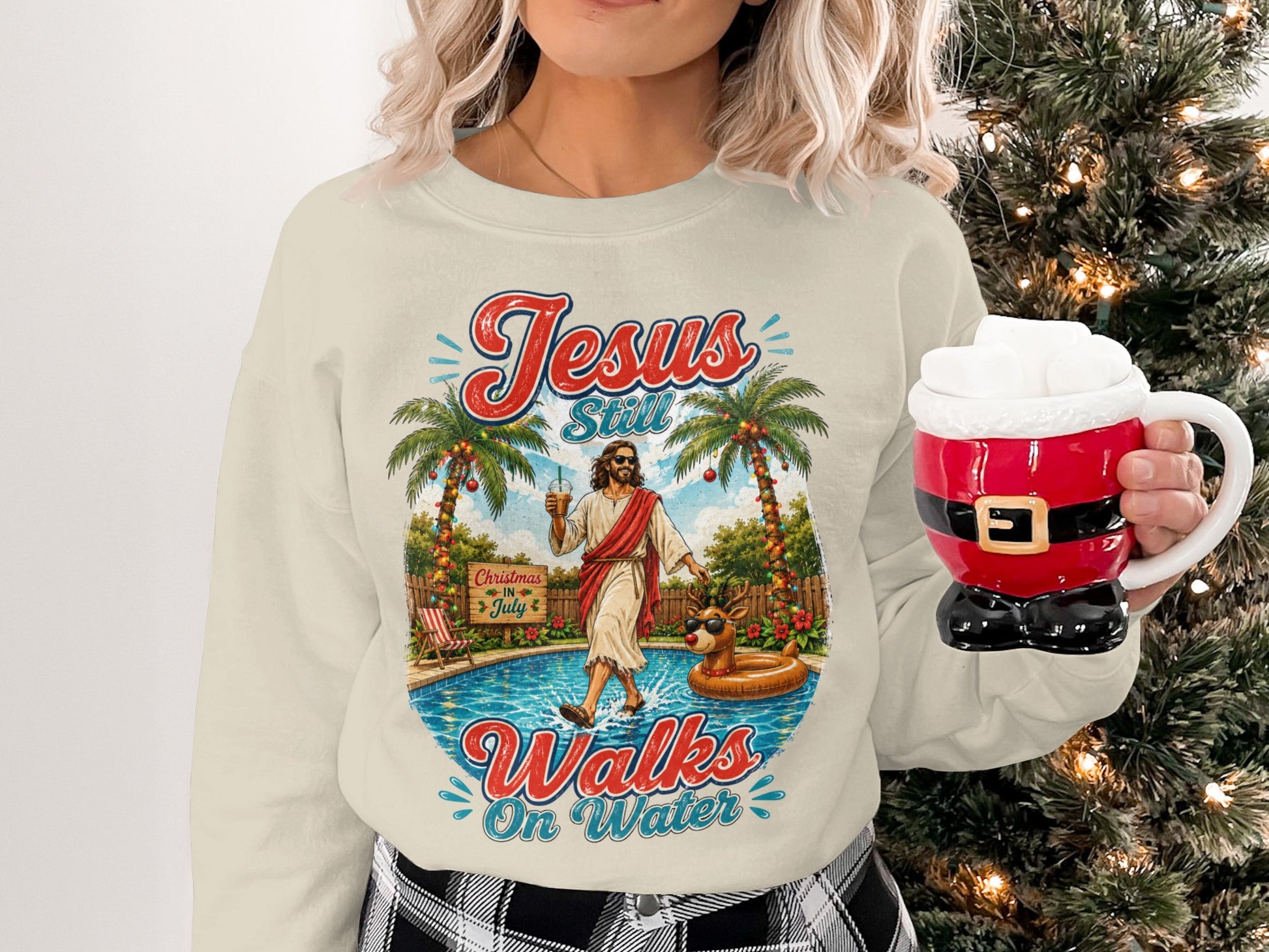 Cream sweatshirt with "Jesus Still Walks On Water" graphic and Christmas decorations.