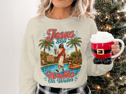 Cream sweatshirt with "Jesus Still Walks On Water" graphic and Christmas decorations.