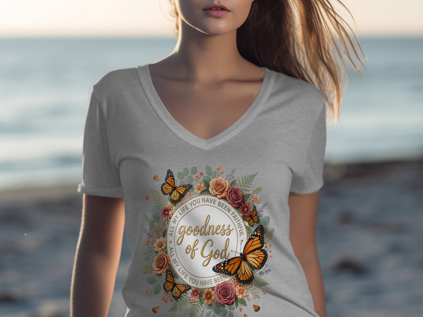 T-shirt with floral wreath, butterflies, and "Goodness of God" text.