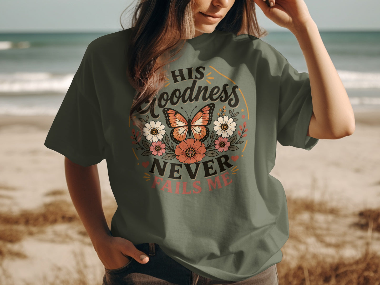 Green t-shirt with "His Goodness Never Fails Me" and floral butterfly graphic.