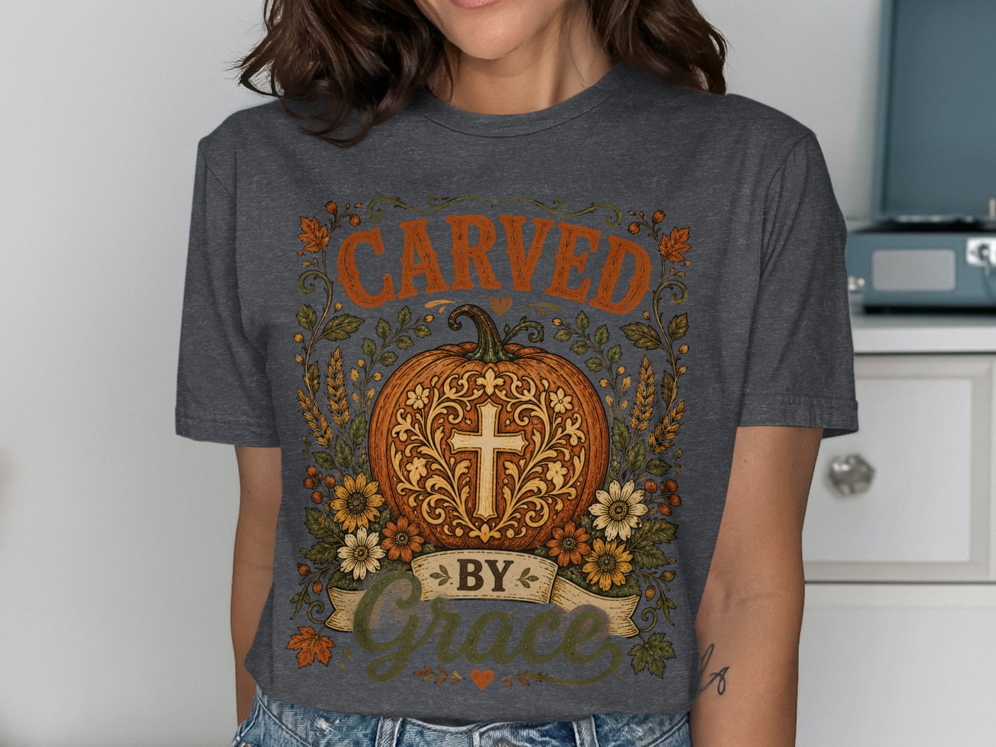 Dark gray t-shirt with pumpkin, cross, and "Carved by Grace" text.