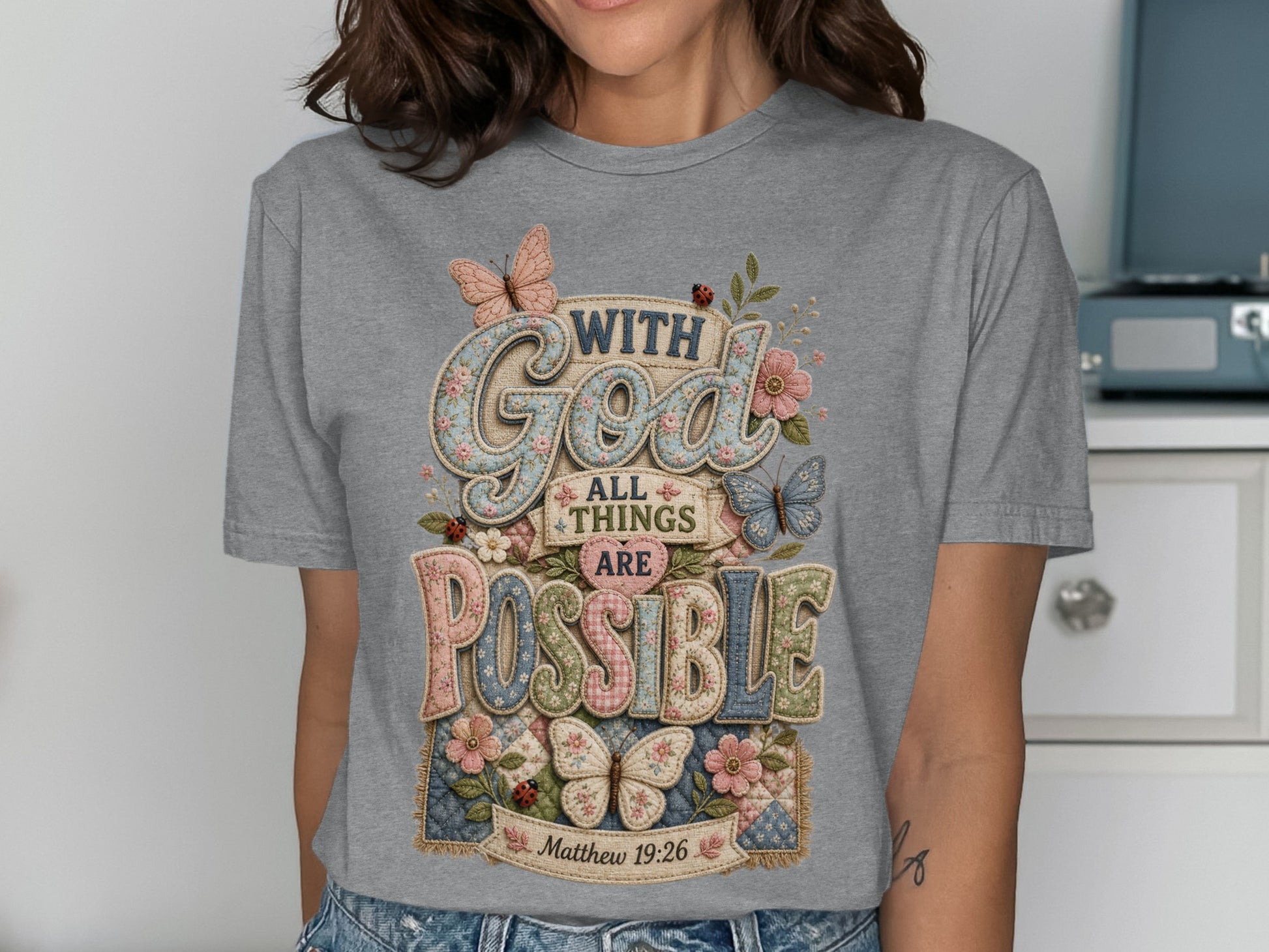 Grey t-shirt with "With God All Things Are Possible" and floral accents.