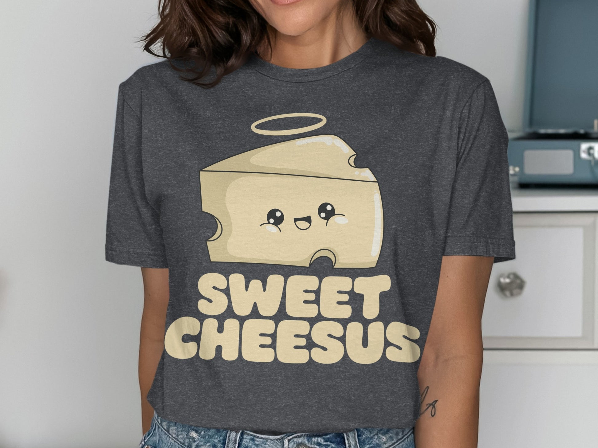 T-shirt with a smiling cheese wedge with a halo and the text "Sweet Cheesus".