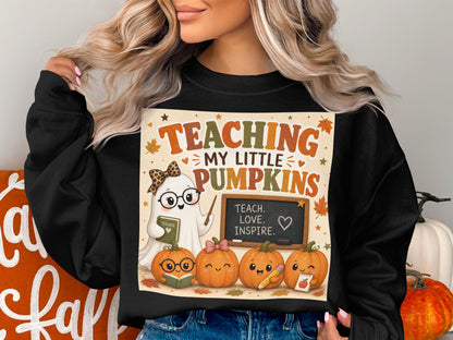 Ghost with glasses holding a book next to pumpkins and text that says Teaching My Little Pumpkins.