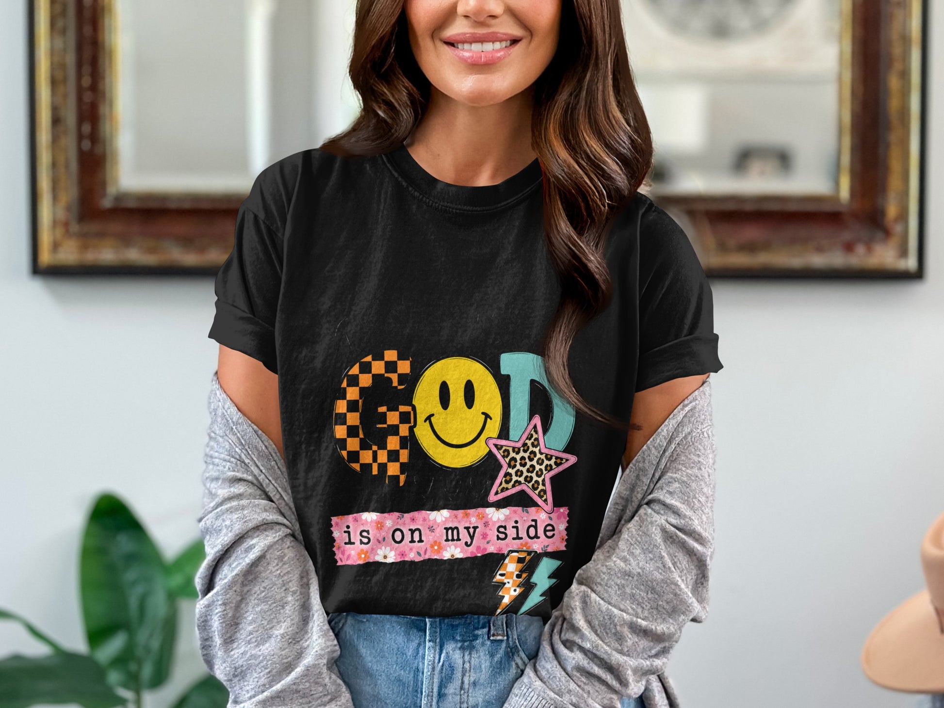T-shirt with "GOD is on my side" text, smiley face, and stars.