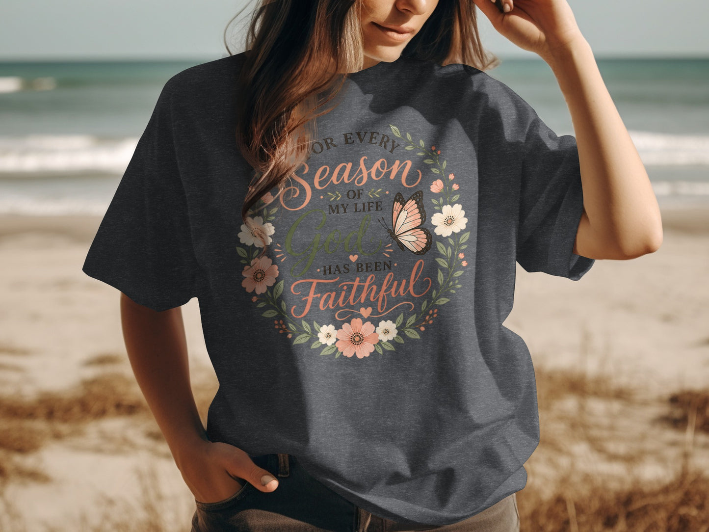 Dark t-shirt with floral wreath and butterfly, reads "For every season of my life God has been faithful".