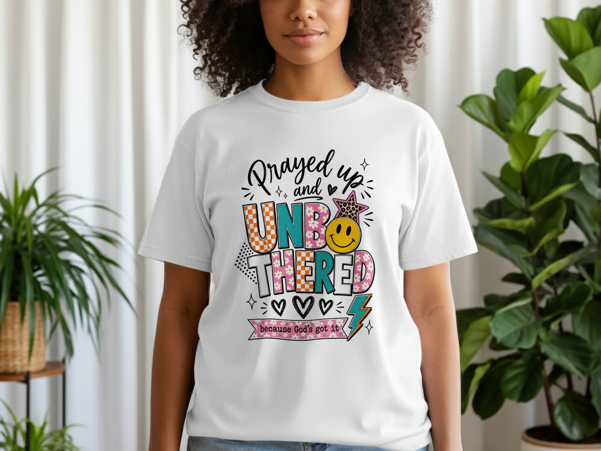 White t-shirt with "Prayed up and Unbothered because God's got it" graphic.