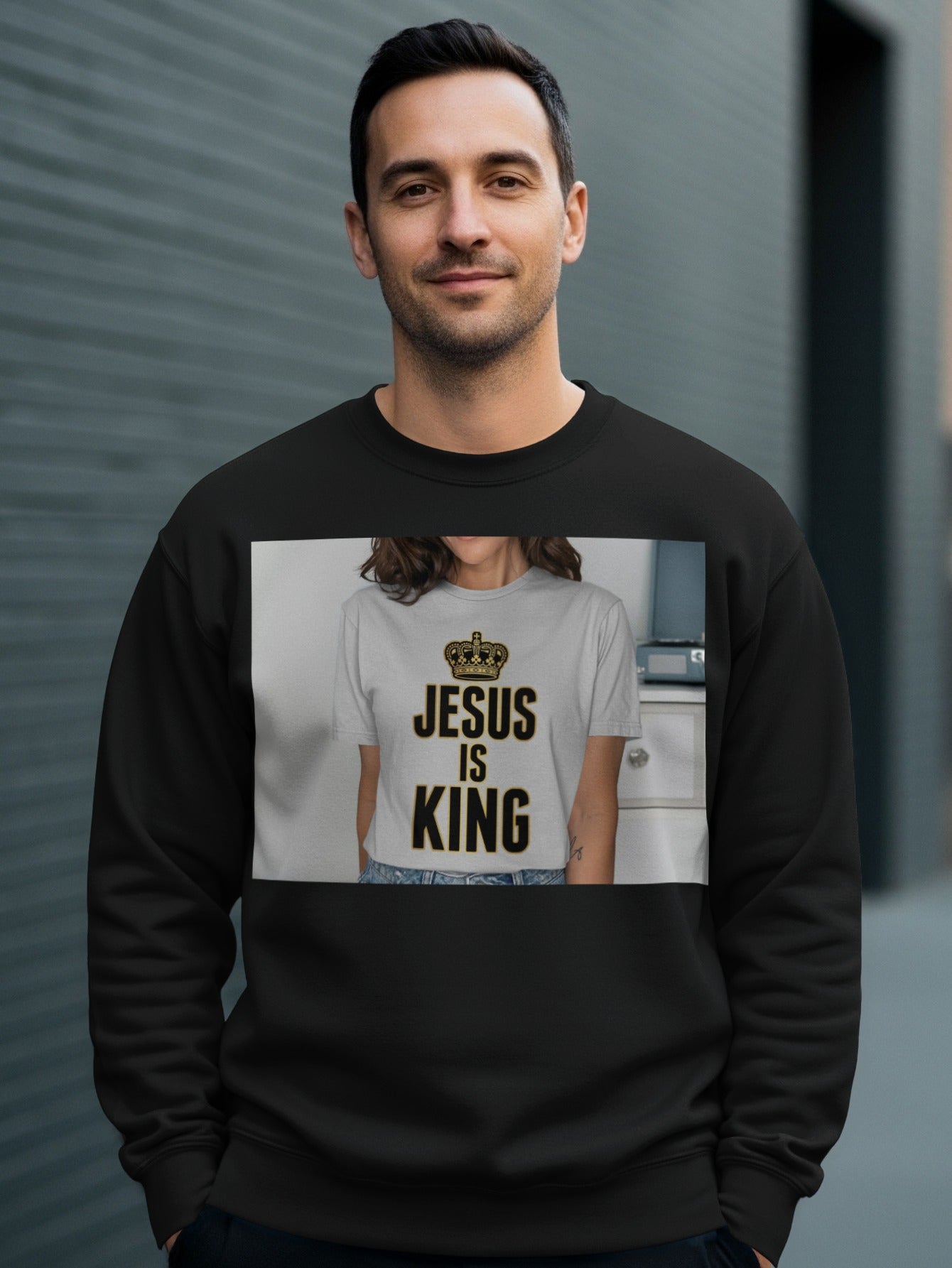 Man wearing black sweatshirt with "Jesus Is King" text and crown graphic.