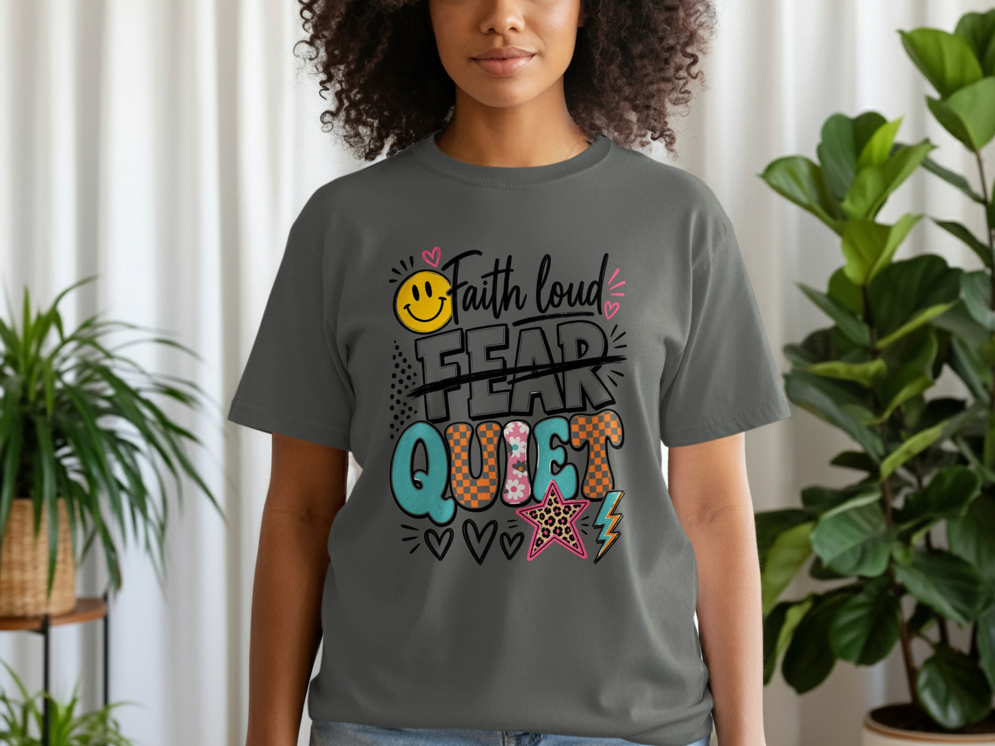 Dark grey t-shirt with text "Faith loud, Fear quiet" and graphic elements.
