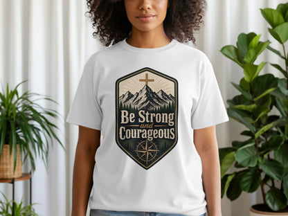 White t-shirt with "Be Strong and Courageous" text and mountain graphic.