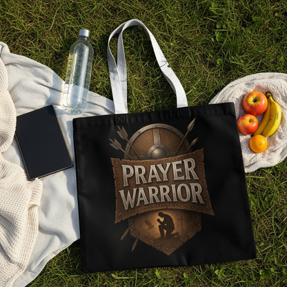Black tote bag with "Prayer Warrior" text, shield, arrows, and praying figure.