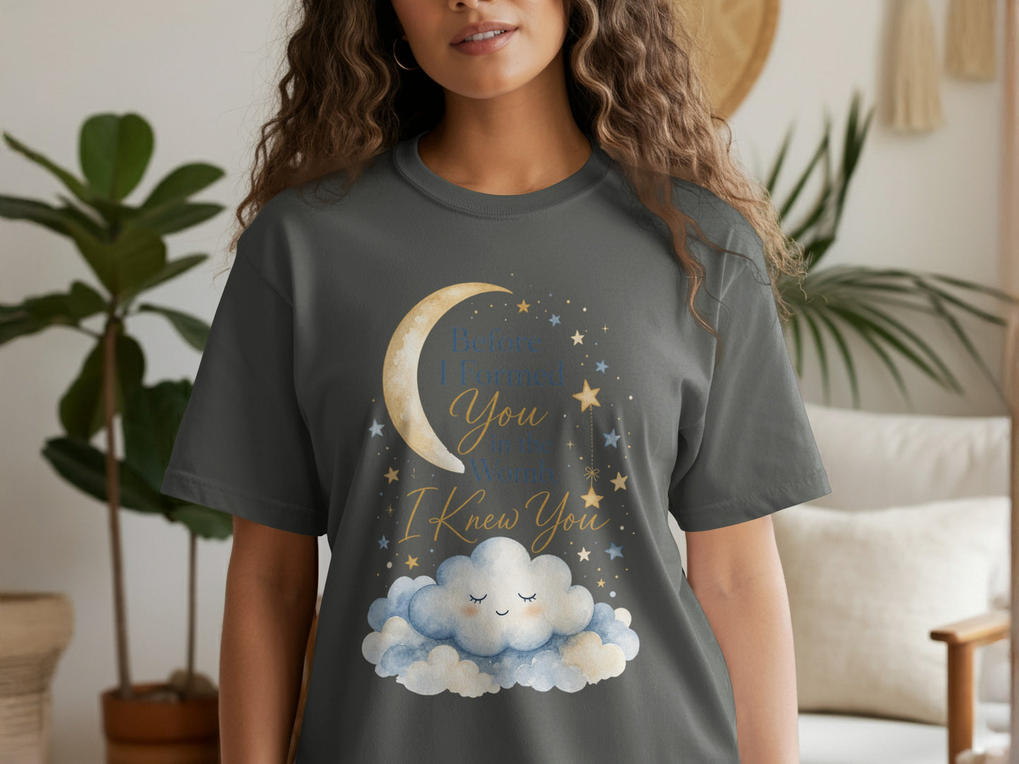 Dark grey t-shirt with moon, stars, and clouds graphic reading "Before I Formed You in the Womb, I Knew You."