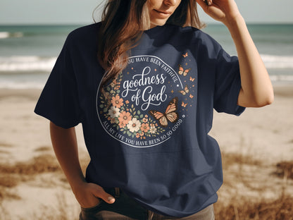 Navy t-shirt with floral circle and "Goodness of God" text.