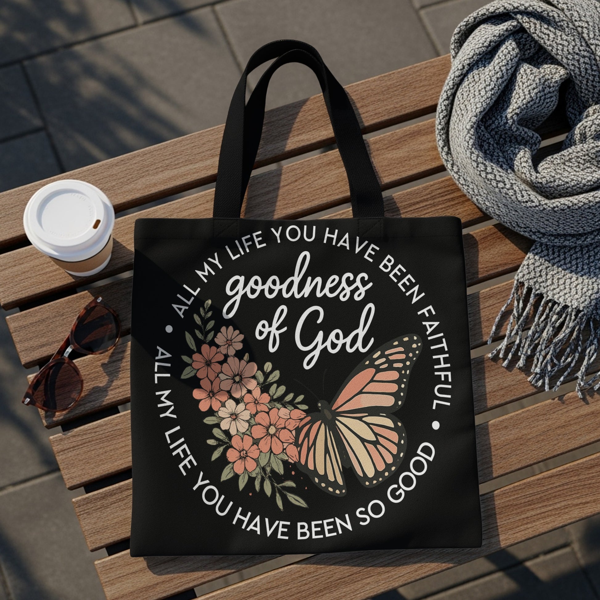 Black tote bag with butterfly and floral design, reading "goodness of God."