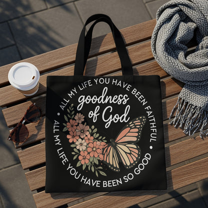 Black tote bag with butterfly and floral design, reading "goodness of God."