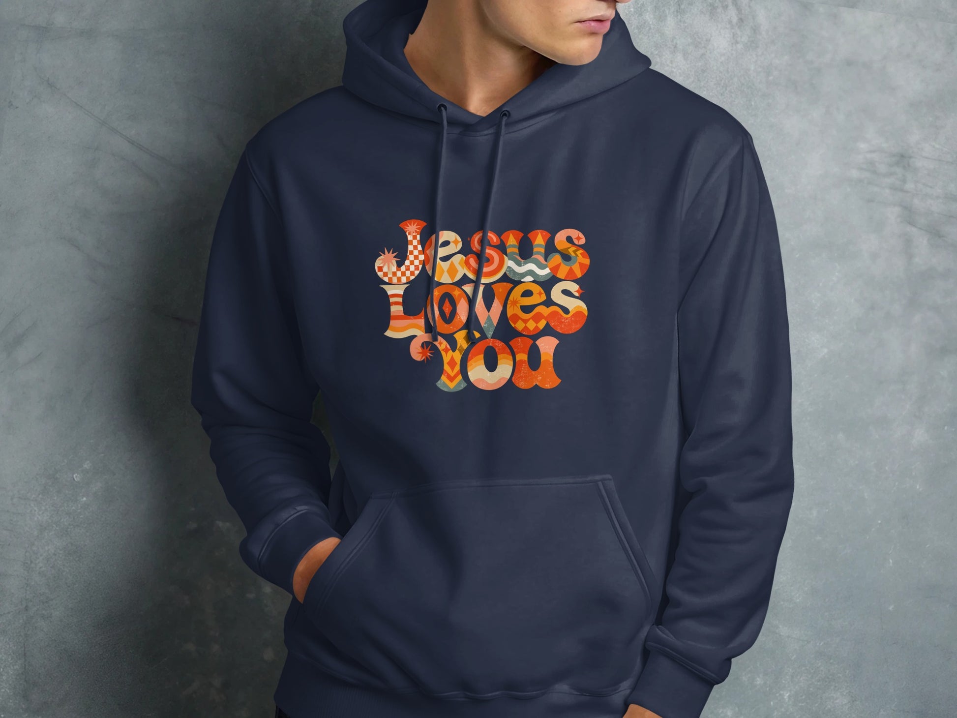 Navy hoodie with colorful "Jesus Loves You" text on the chest.