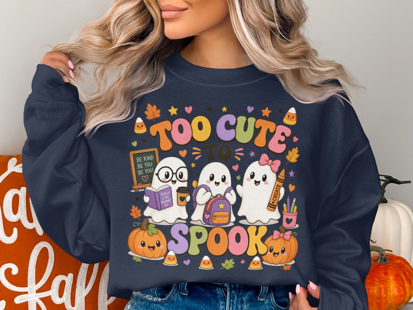 Three ghosts wearing backpacks and holding school supplies with pumpkins and candy corn, text reads "Too Cute To Spook."