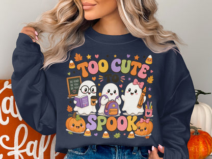 Three ghosts wearing backpacks and holding school supplies with pumpkins and candy corn, text reads "Too Cute To Spook."