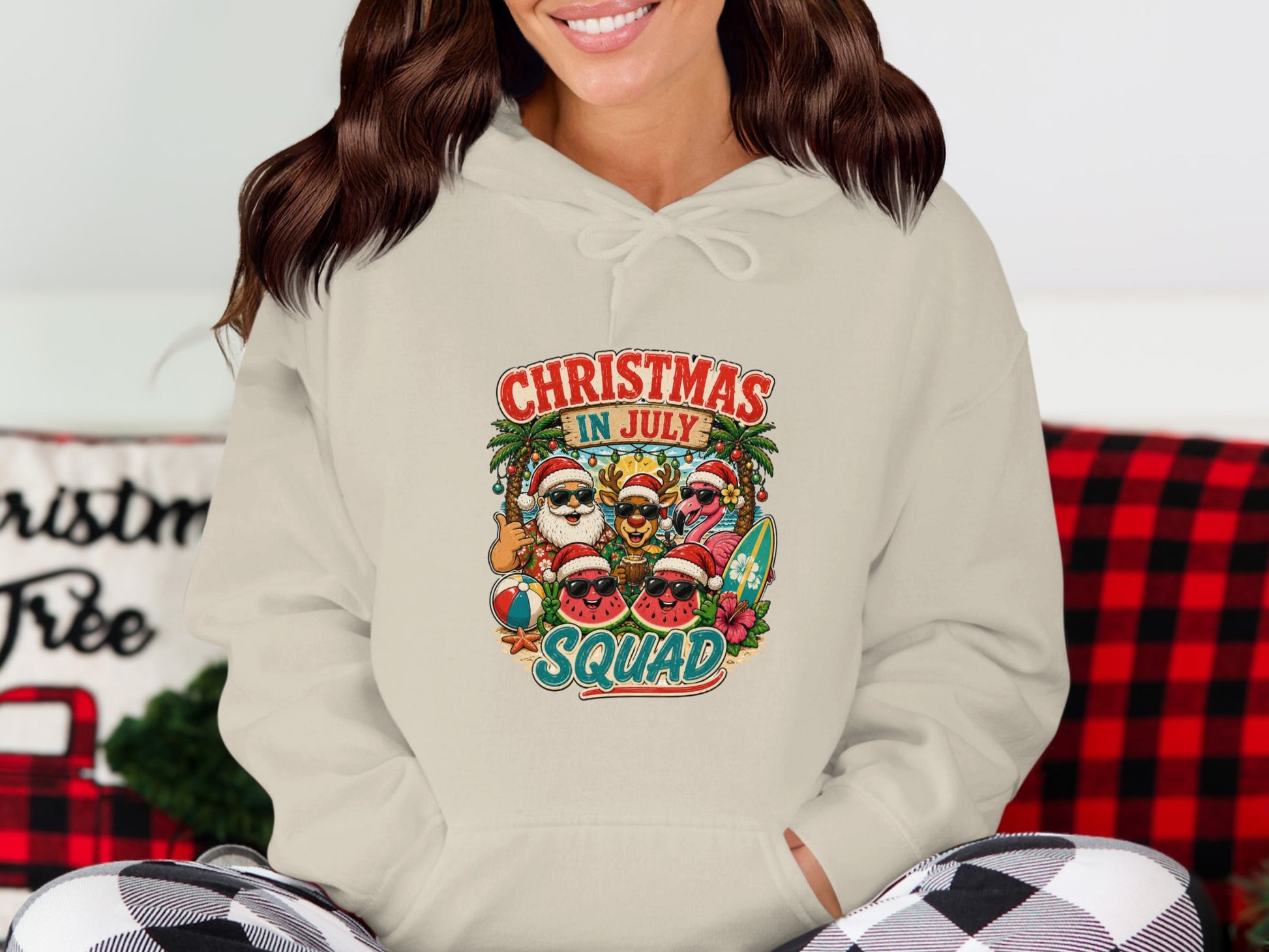 Cream hoodie with "Christmas in July Squad" graphic featuring Santa and summer characters.