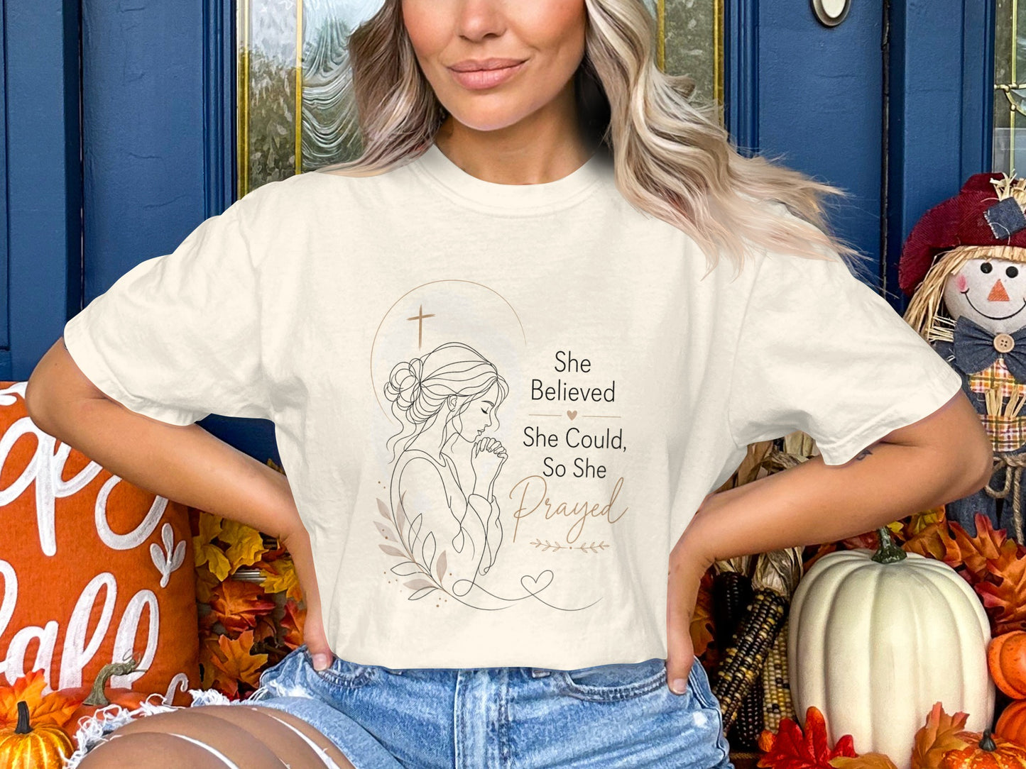 Cream t-shirt with line art of woman praying and text "She Believed She Could, So She Prayed".