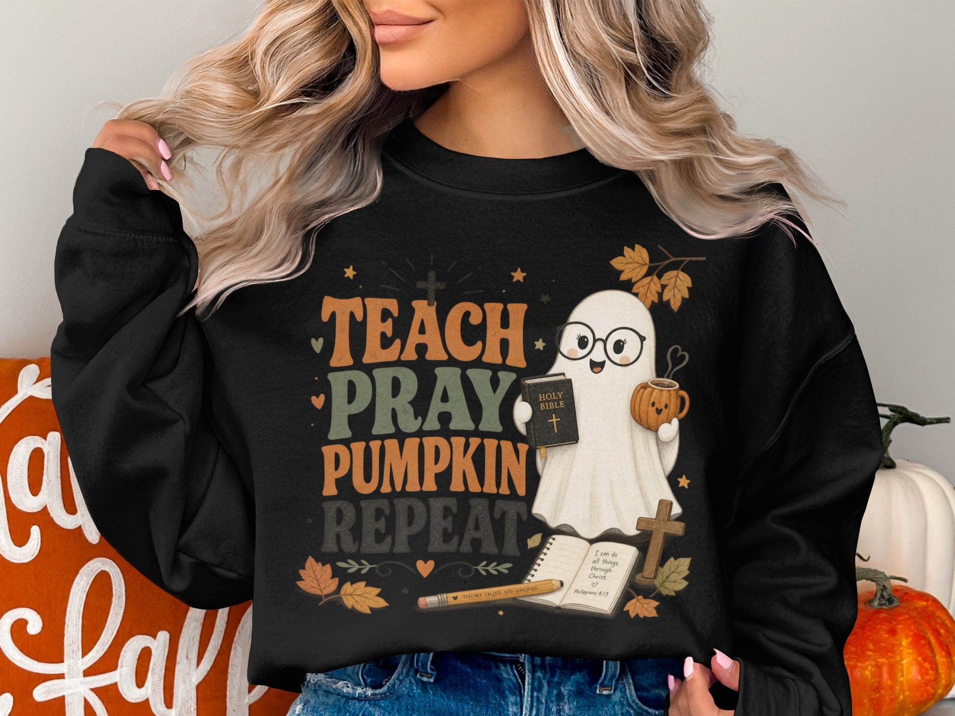 Black sweatshirt with "Teach Pray Pumpkin Repeat" and a ghost holding a Bible and pumpkin mug.