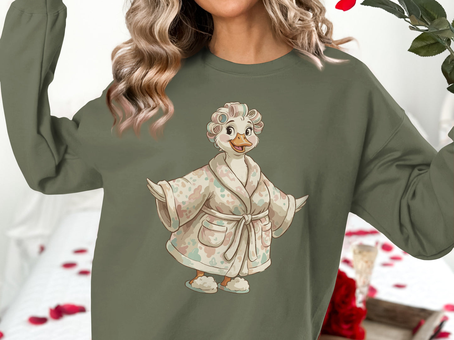 Green sweatshirt with a cartoon duck wearing a bathrobe and hair curlers.
